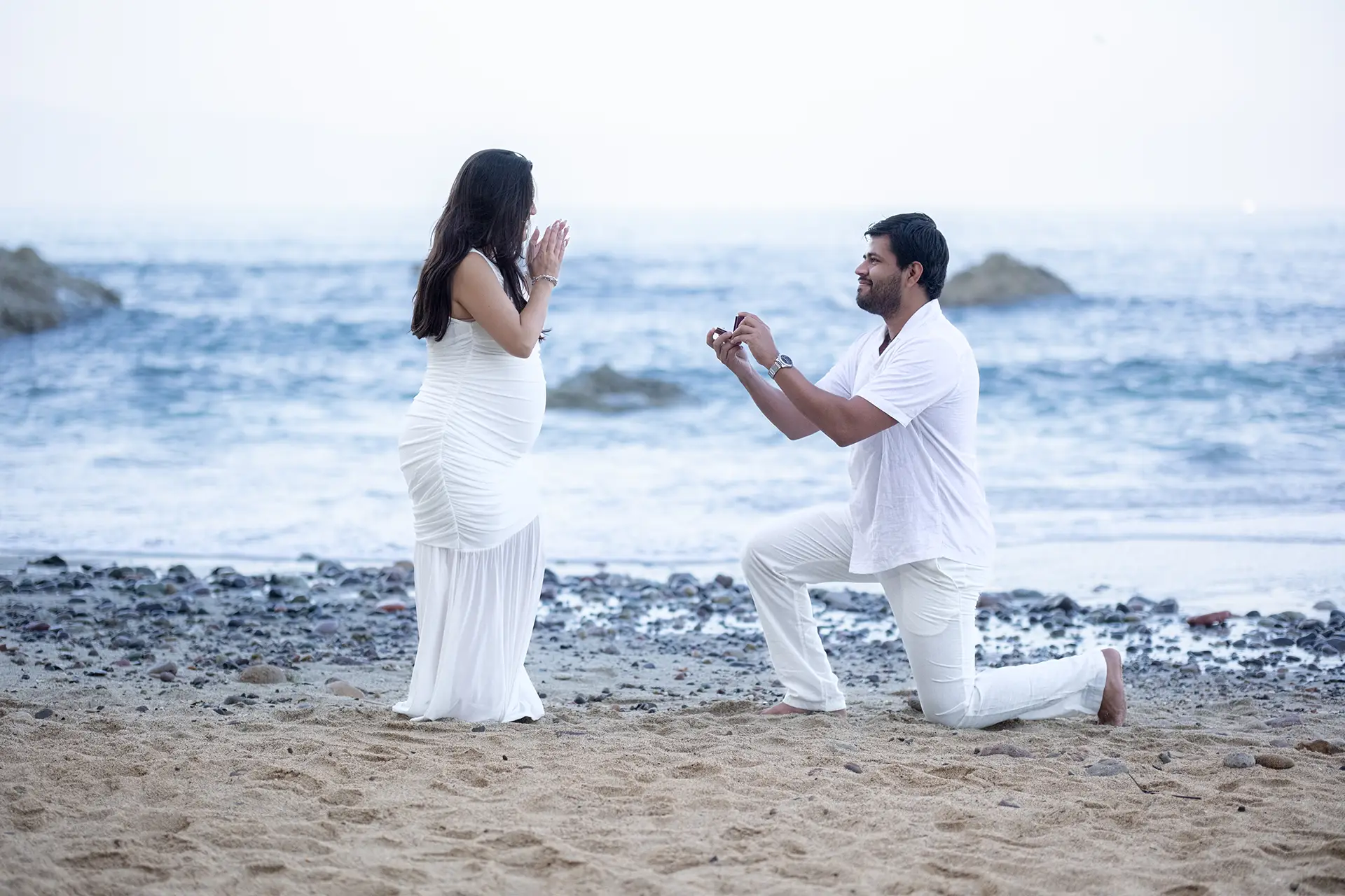 Beach proposal to a pregnant partner on a rocky Puerto Vallarta shoreline