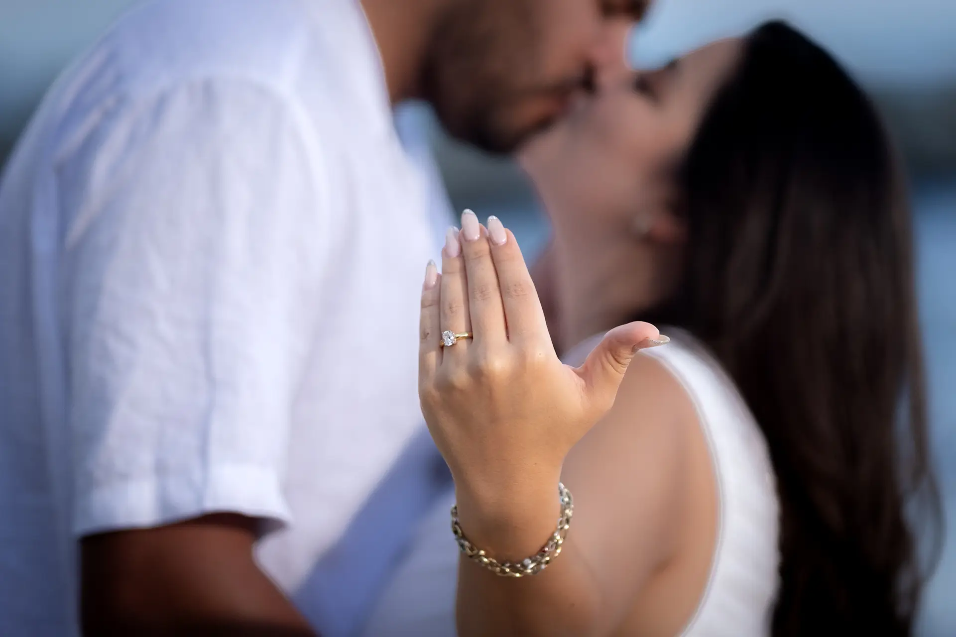 Close-up of an engagement ring as the couple kisses in Puerto Vallarta