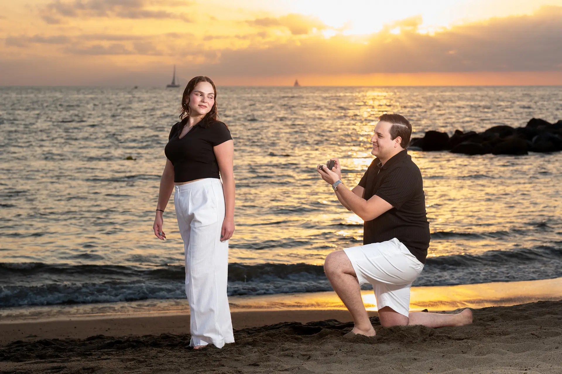 Man proposing with a ring box on the beach at sunset in Puerto Vallarta