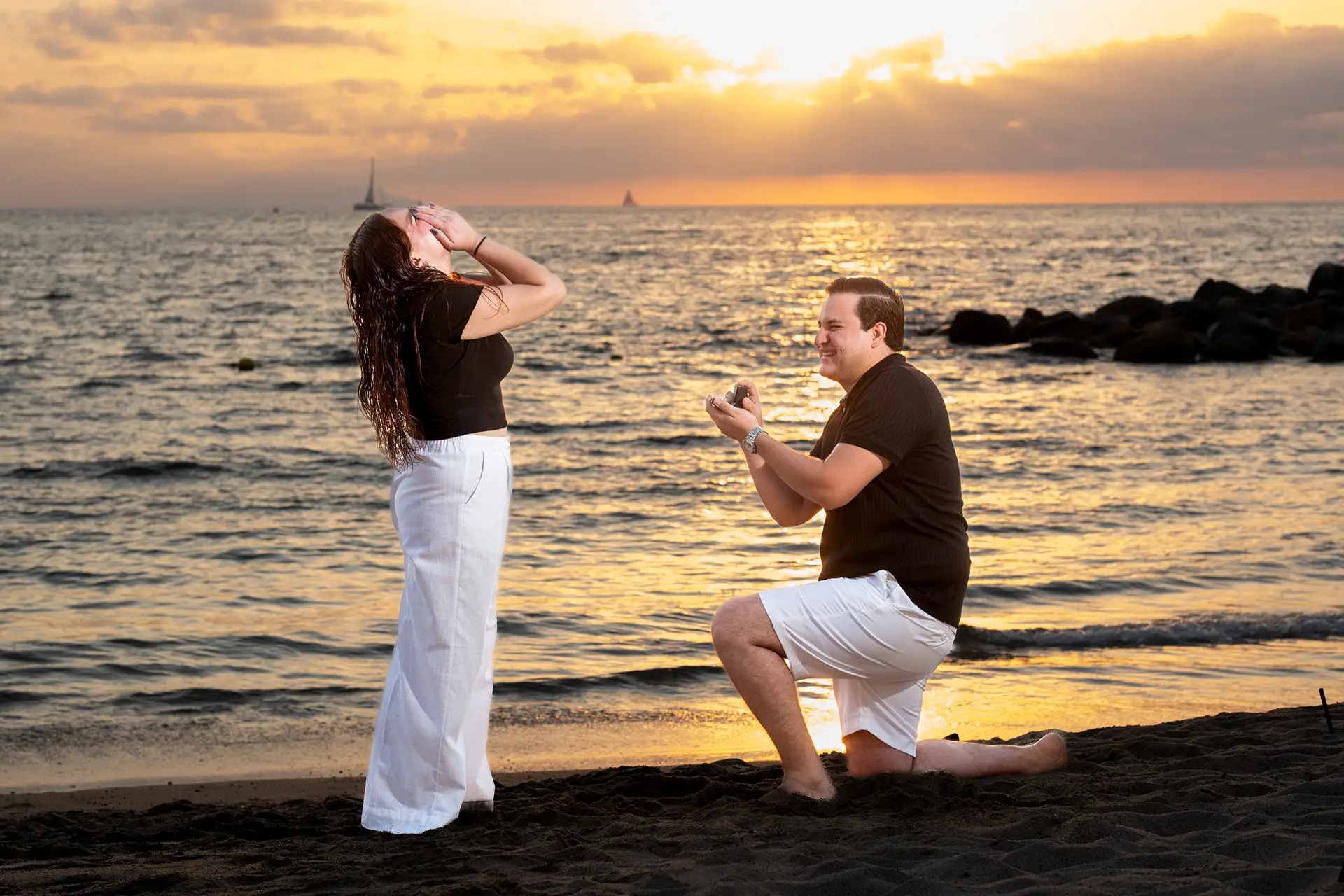 Couple embracing at sunset after a surprise marriage proposal on a Puerto Vallarta beach