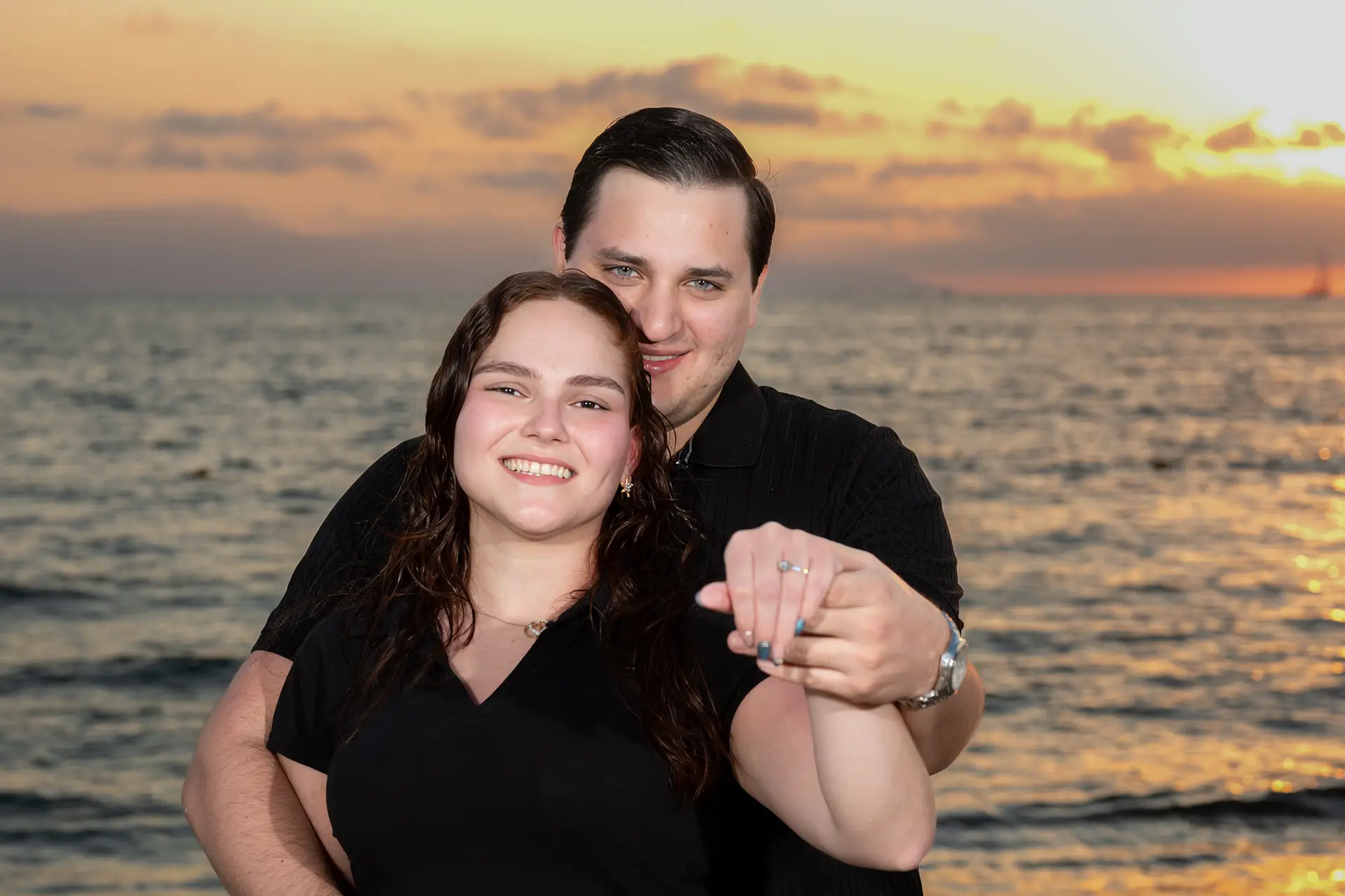Newly engaged couple embracing at sunset in Puerto Vallarta