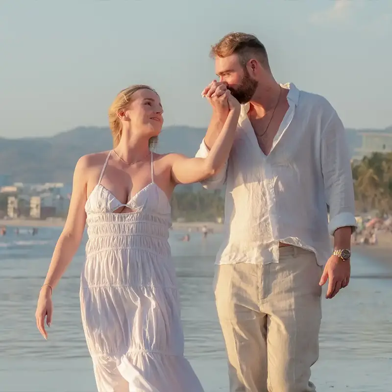 Couple walking together along the shoreline during a vacation photo session in Puerto Vallarta