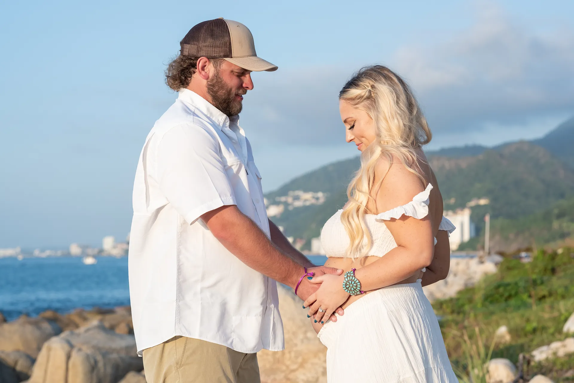 Expecting couple facing each other with the bump between them in Puerto Vallarta
